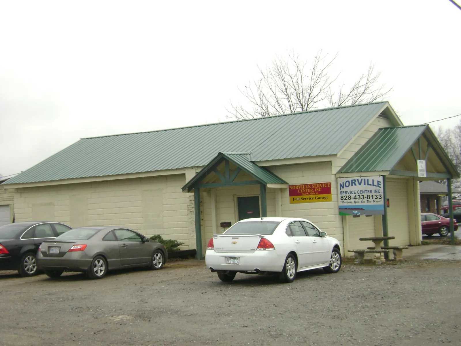 Green metal roof on a service garage with a covered entry in Pell City